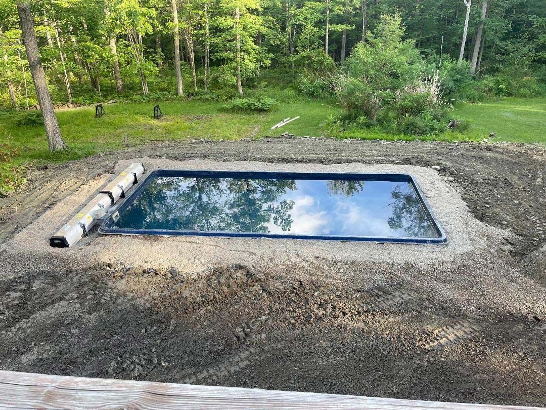 Pool construction and tall trees in backyard