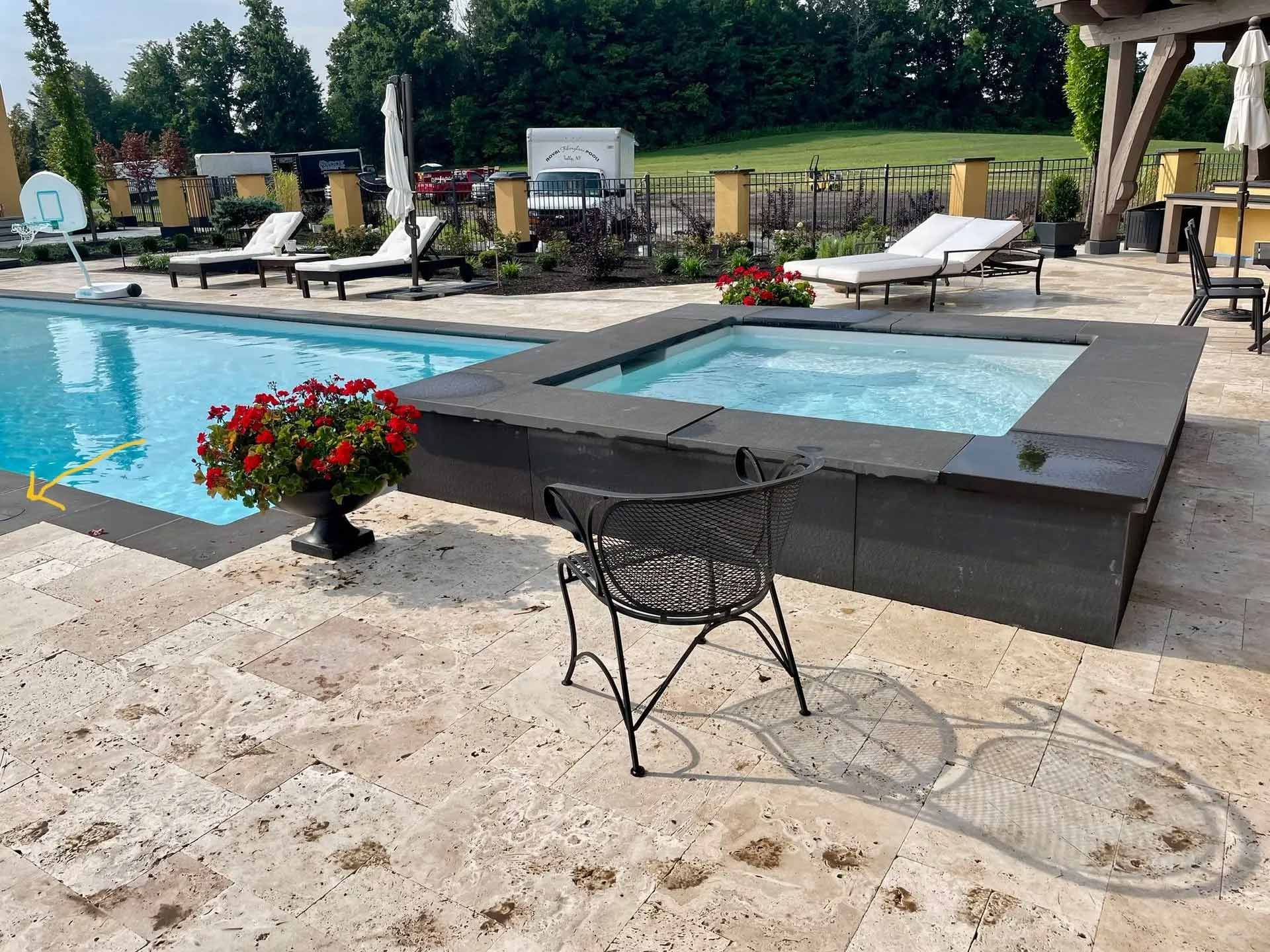 Backyard pool patio with a hot tub