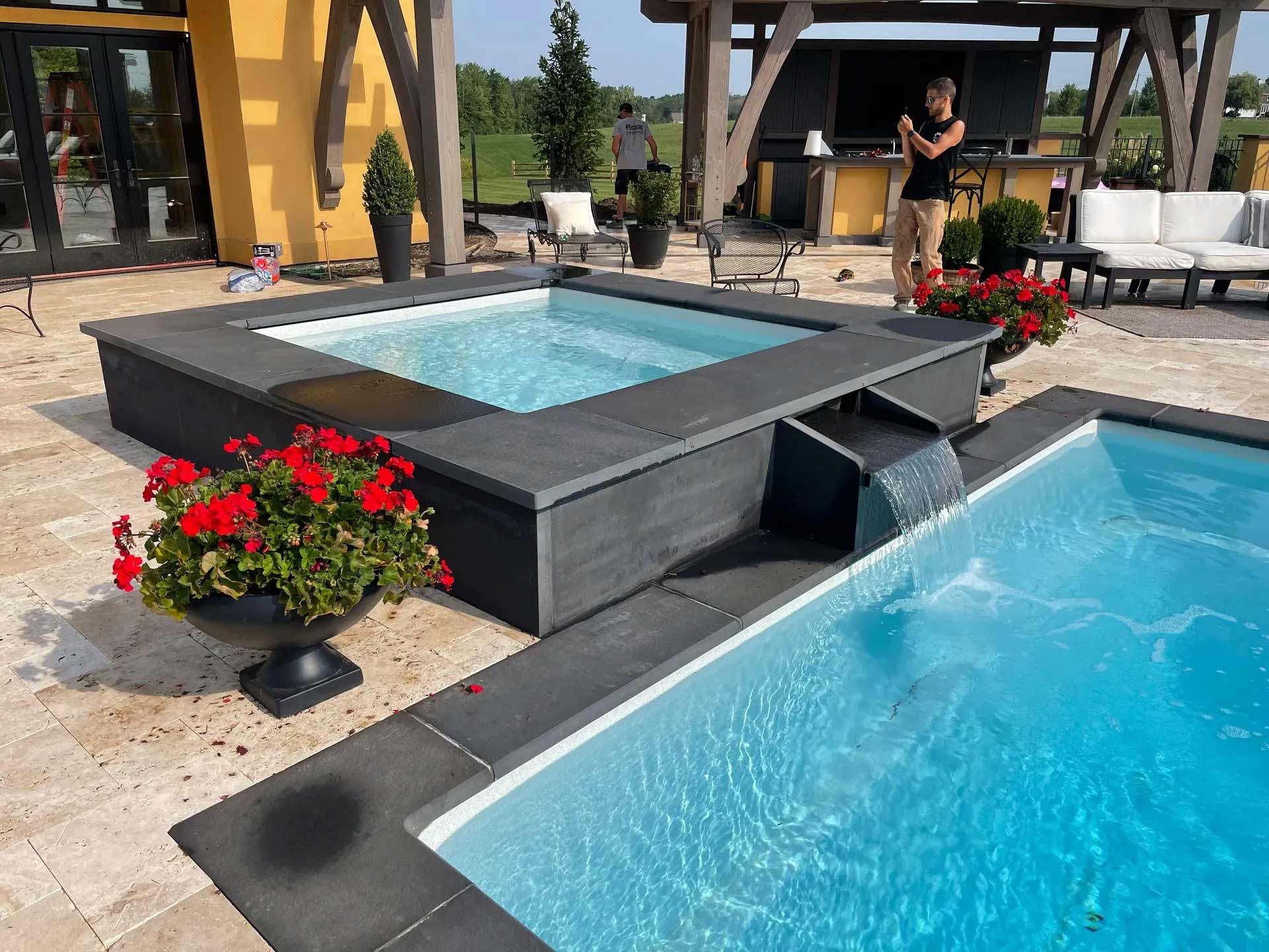 Modern patio with a raised spa and pool
