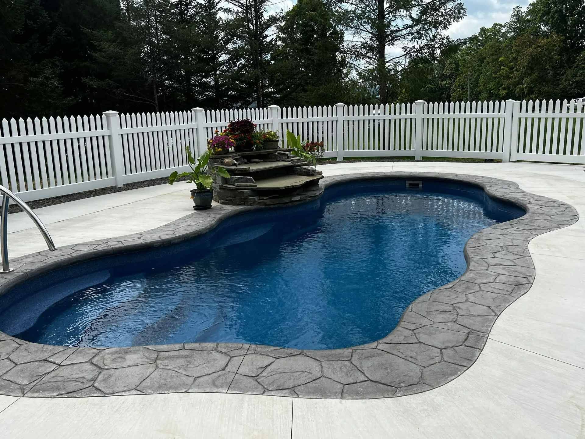 Backyard swimming pool with stone border