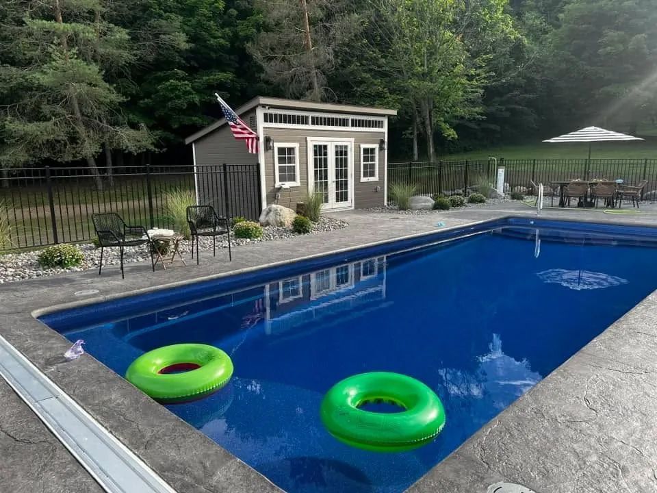 Backyard pool with two green float rings