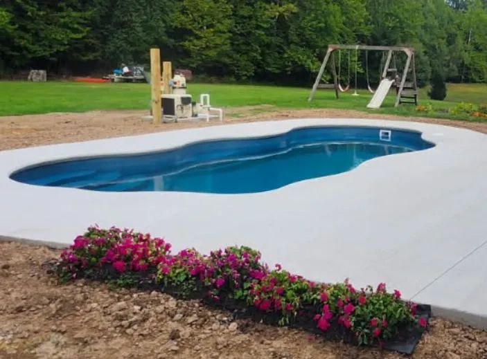 Backyard with an in-ground blue pool