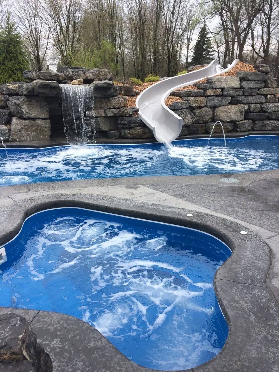 Backyard pool with rock waterfall