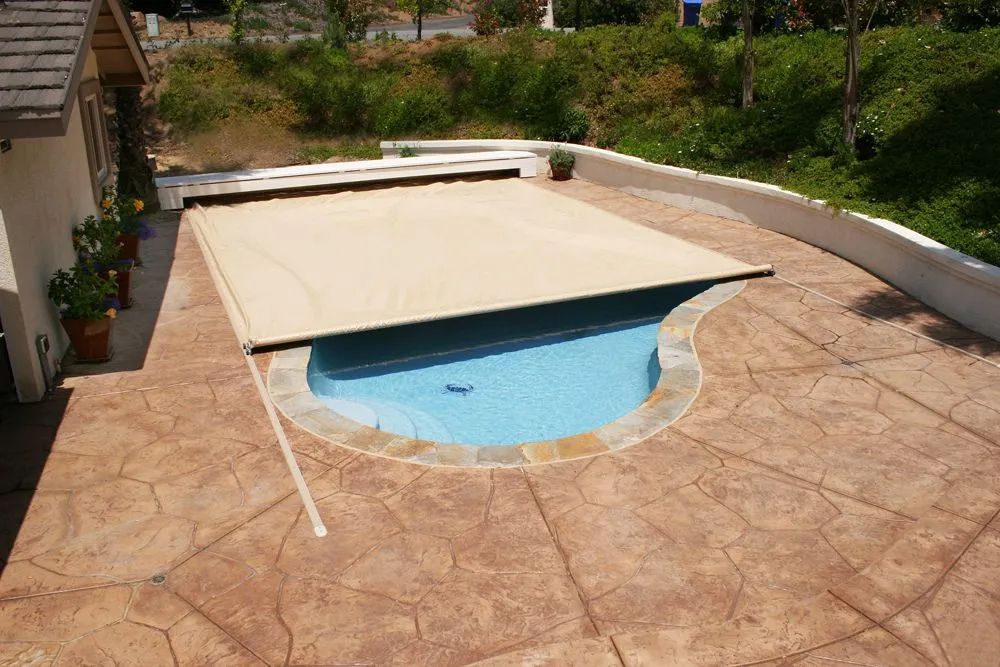 Backyard pool with beige cover