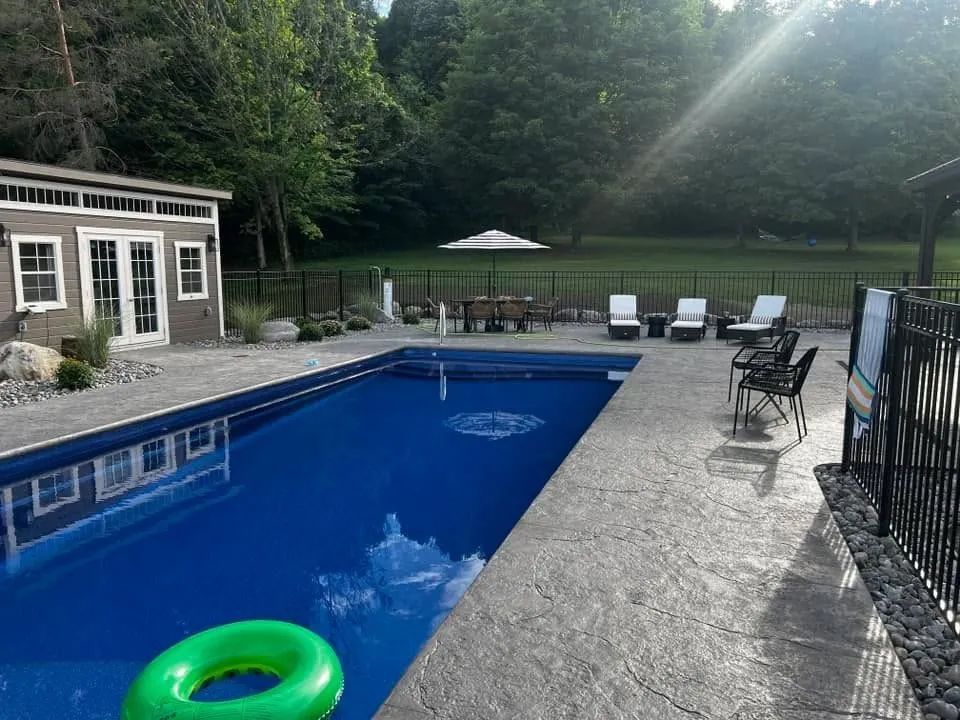 Backyard pool with patio furniture
