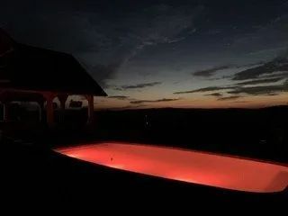 Dim outdoor pool glowing red at dusk