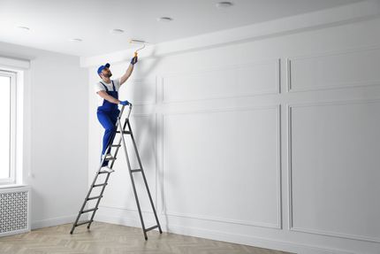 Painters preparing and painting modern living room walls after a professional drywall service in Moreno Valley, CA.