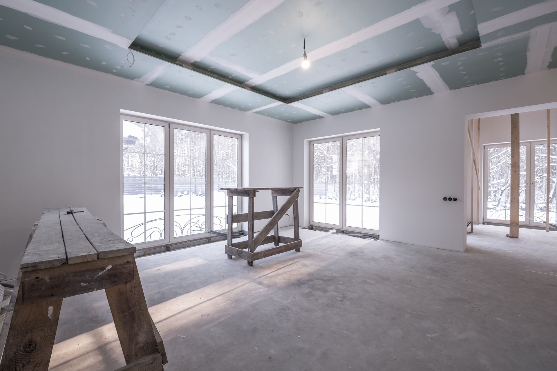 Spacious interior room with high ceilings undergoing drywall finishing and taping service in Moreno Valley, CA.