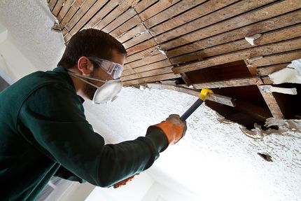 Professional worker repairing a ceiling corner during a drywall service in Moreno Valley, CA.