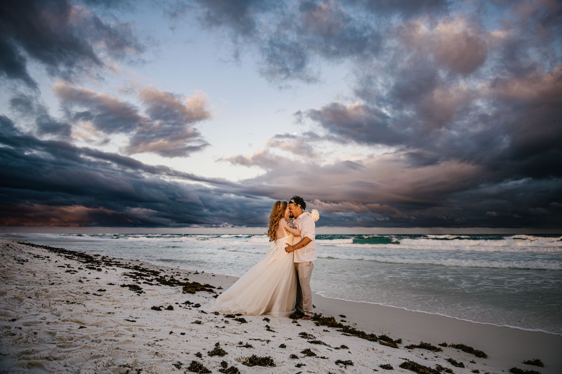 couple kissing on beach at sunset