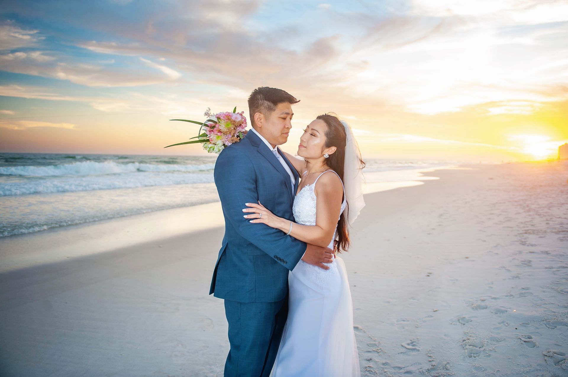 Couple embracing on a beach at sunset, with ocean waves and soft pastel sky
