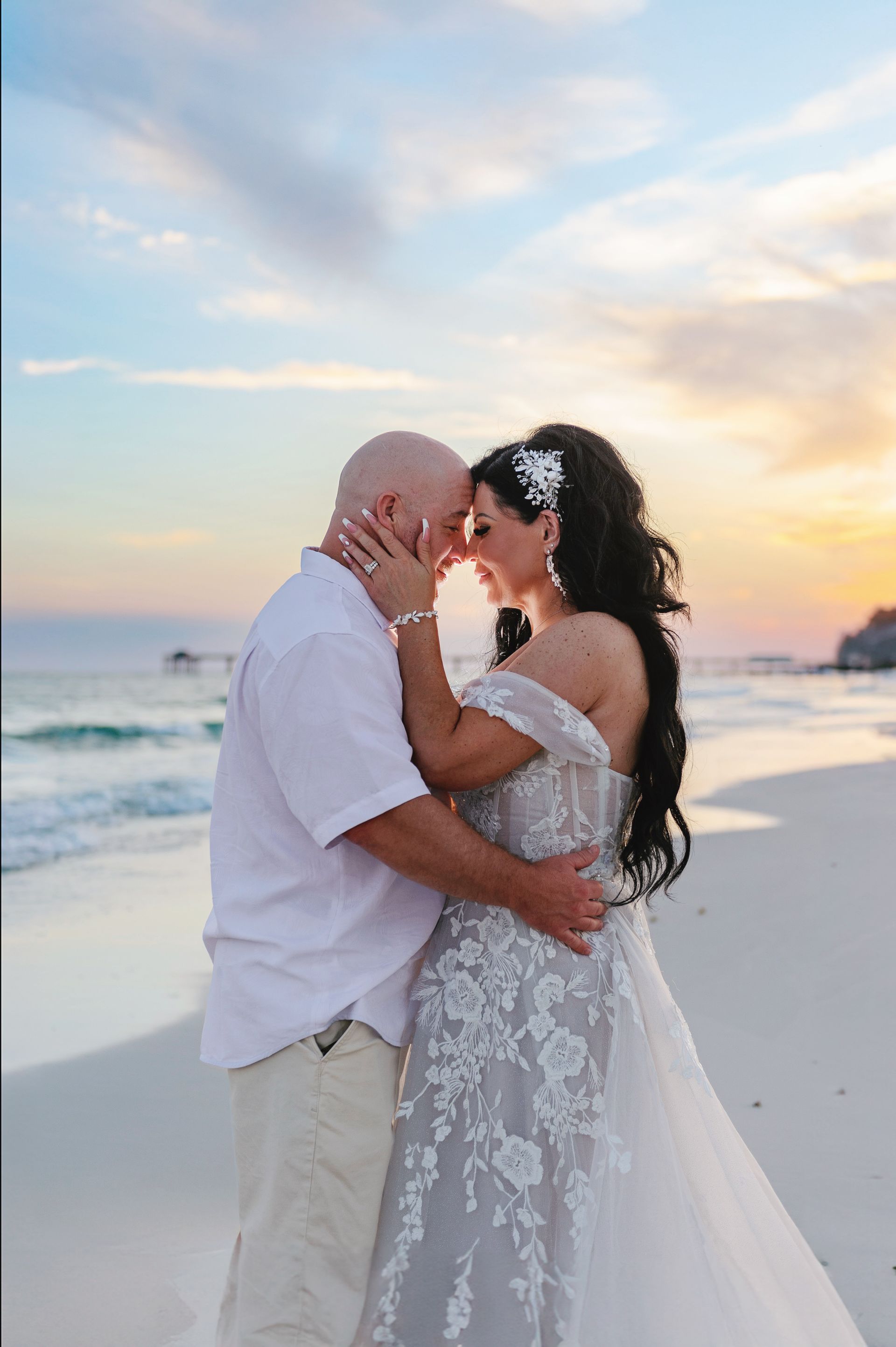 bride and groom embracing during beach wedding ceremony