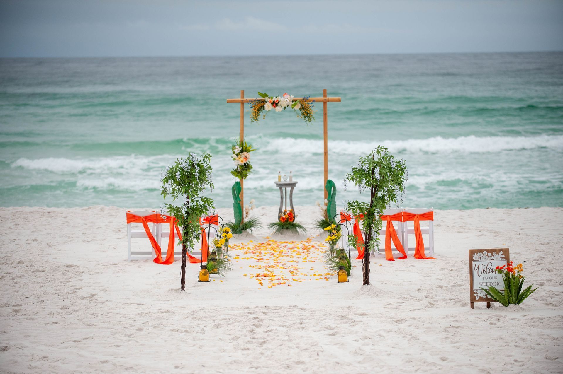 beach wedding ceremony decorated with tropical plants
