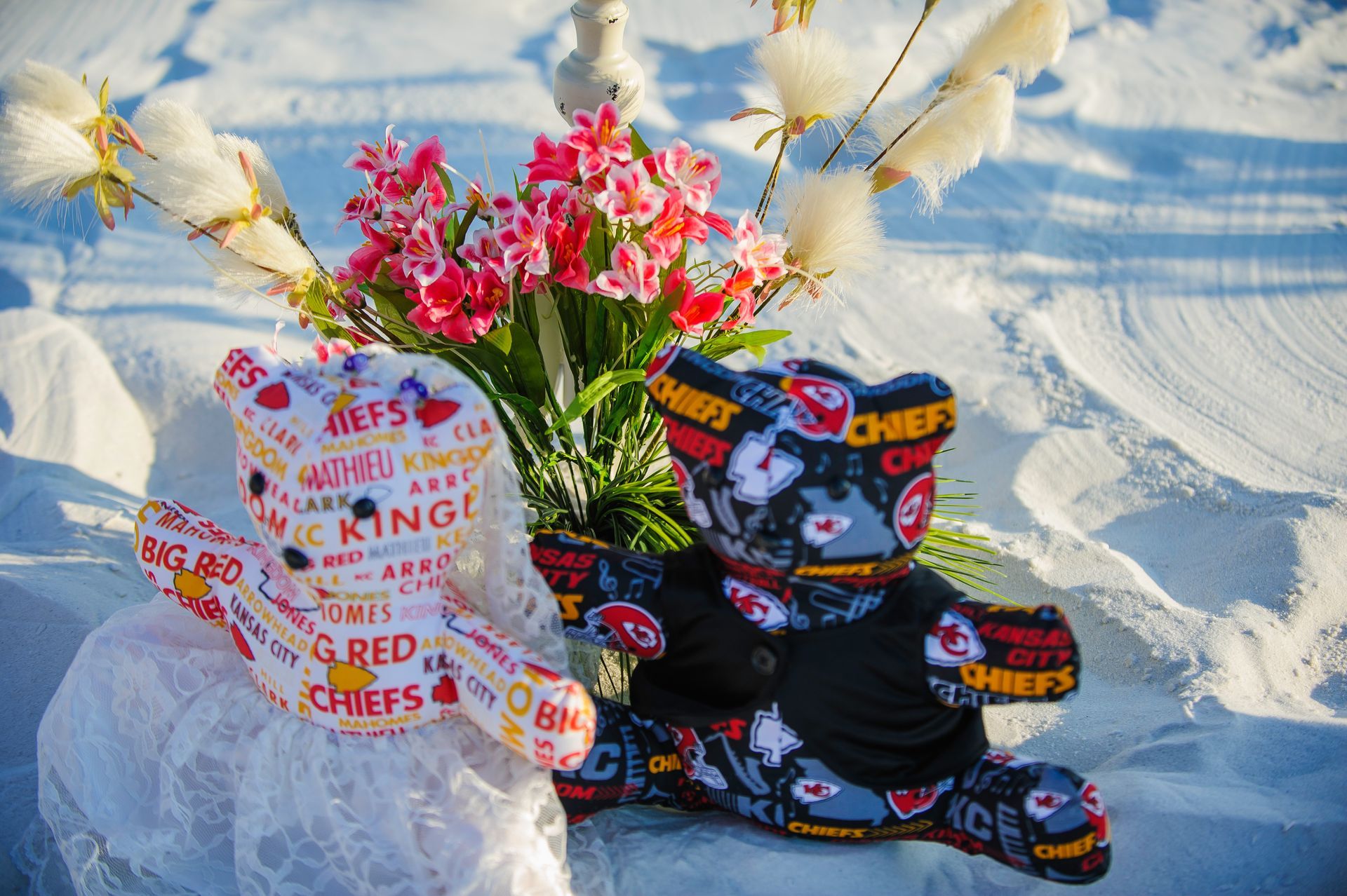 Flowers and gift bags in the snow beside a colorful “Chiefs” mug and blanket display