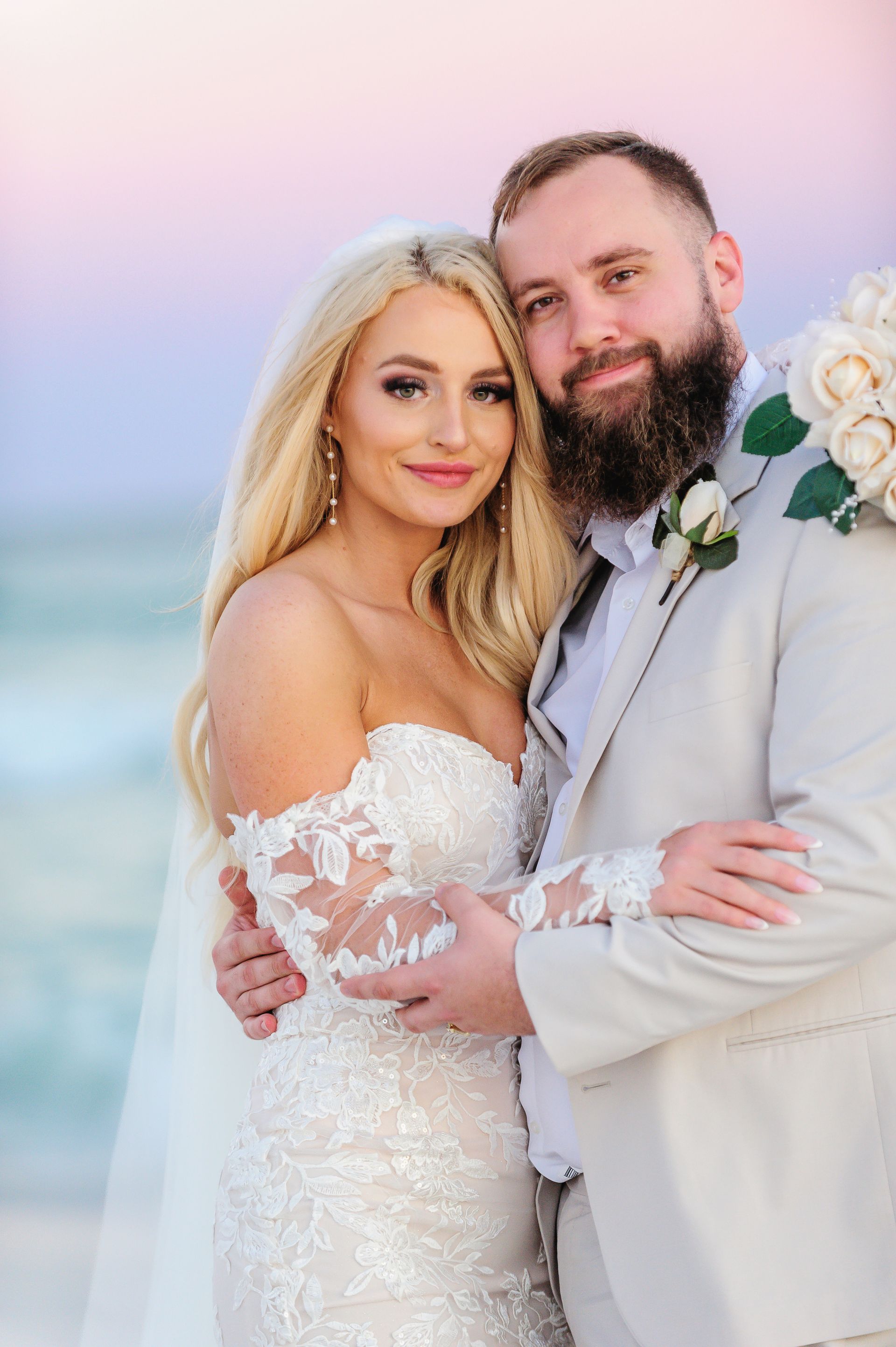 bride and groom embracing at sunset