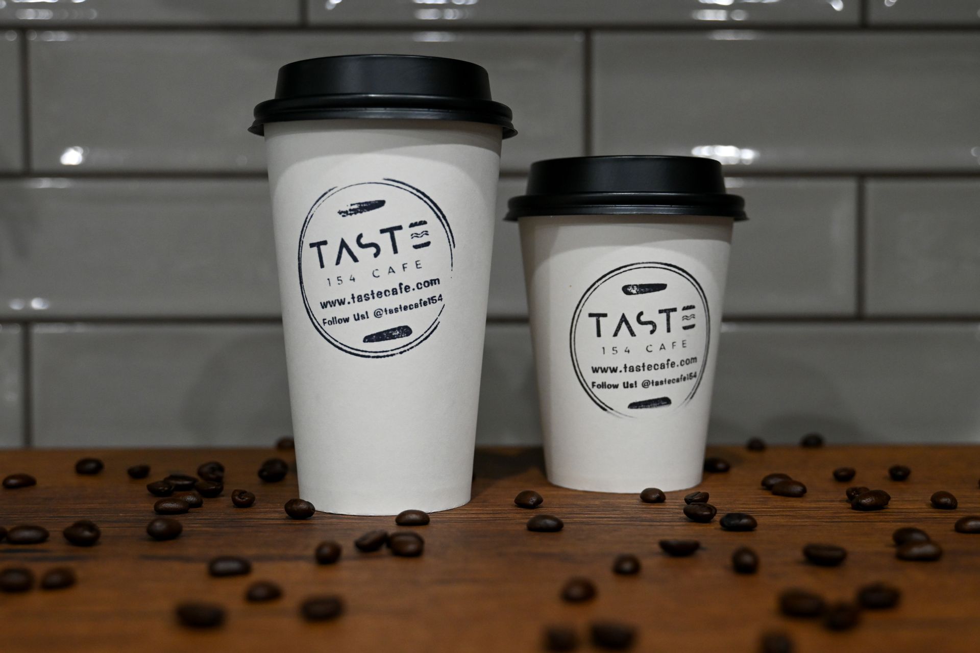 Two coffee cups with the word taste on them
