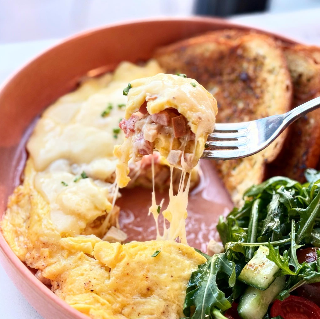 A close up of a plate of food with a fork in it