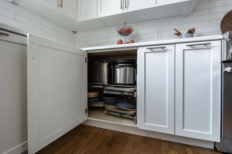 A kitchen with white cabinets and stainless steel appliances.