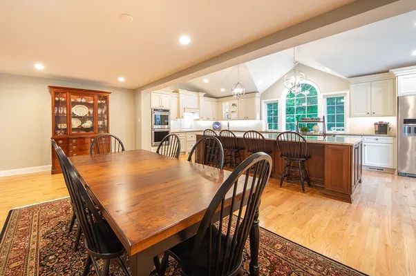 A dining room table and chairs in a kitchen.