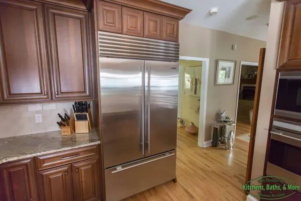 A kitchen with stainless steel appliances and wooden cabinets