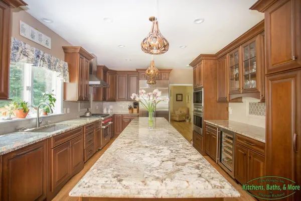 A kitchen with wooden cabinets and granite counter tops