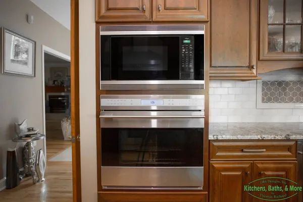 A kitchen with stainless steel appliances and wooden cabinets