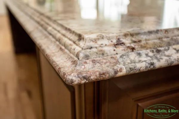 A close up of a granite counter top in a kitchen.