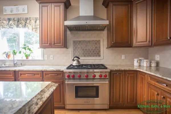 A kitchen with stainless steel appliances and wooden cabinets.