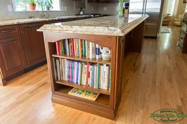 A kitchen island with a bookshelf filled with books.