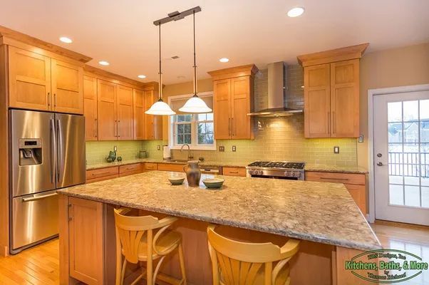 A kitchen with stainless steel appliances and wooden cabinets