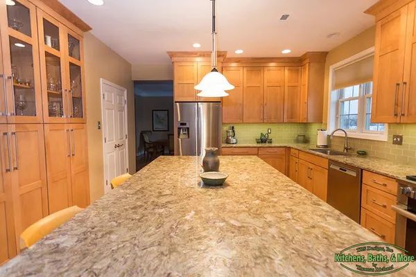 A kitchen with wooden cabinets and granite counter tops