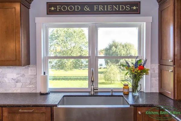 A kitchen sink with a sign above it that says