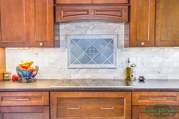 A kitchen with wooden cabinets and a stove top oven.