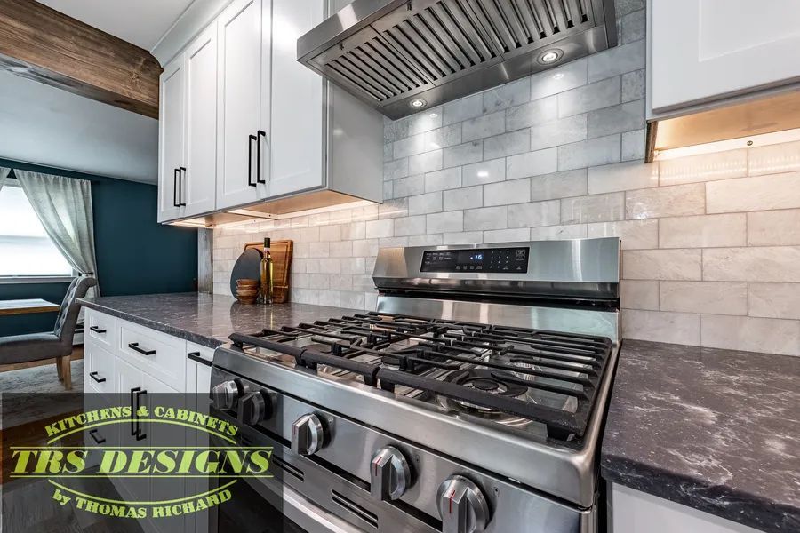 A stove top oven is sitting on top of a counter in a kitchen.