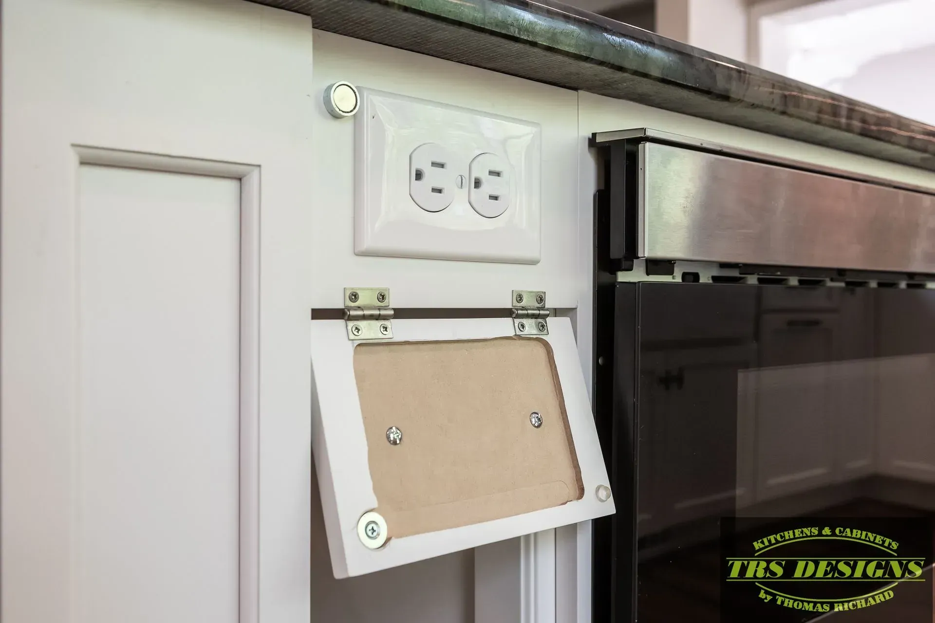 A wall outlet in a kitchen.