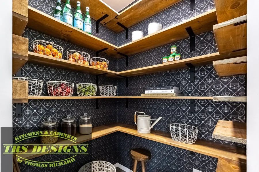 A picture of a pantry with wooden shelves and a sign that says this designs.