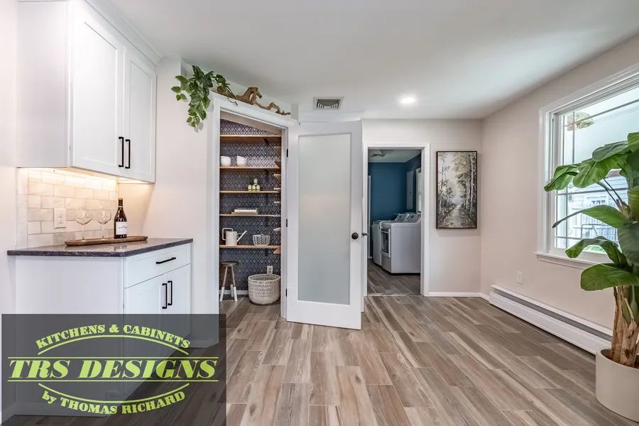 A laundry room with a pantry and a washer and dryer.