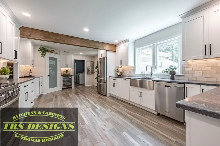 A kitchen with cabinets and stainless steel appliances.