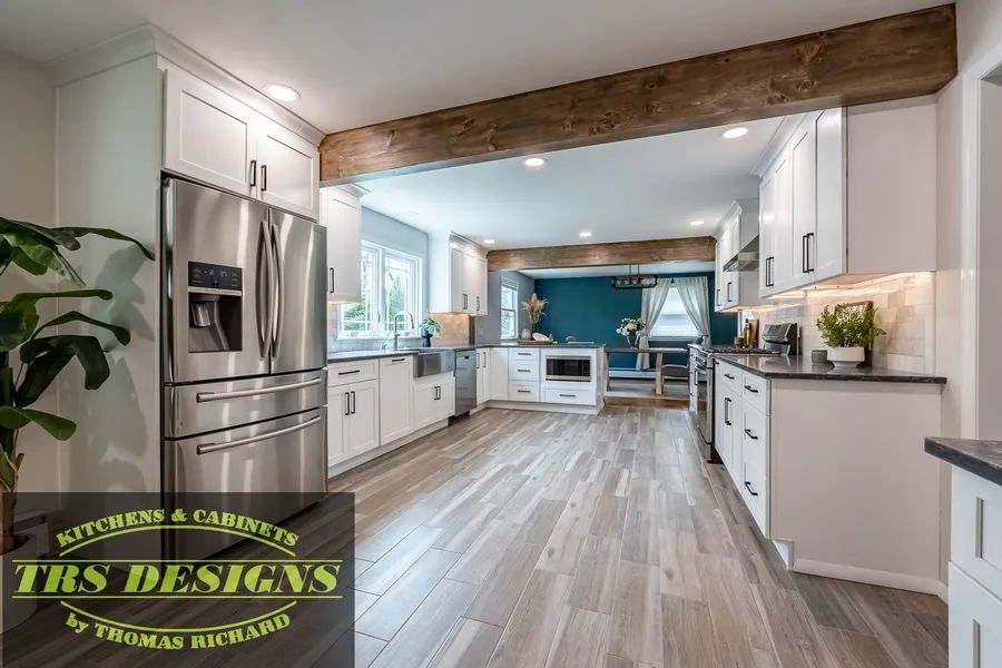 A kitchen with white cabinets.