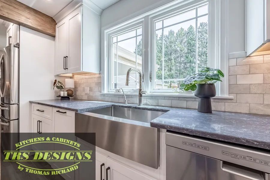 A kitchen with a stainless steel sink and a stainless steel dishwasher.