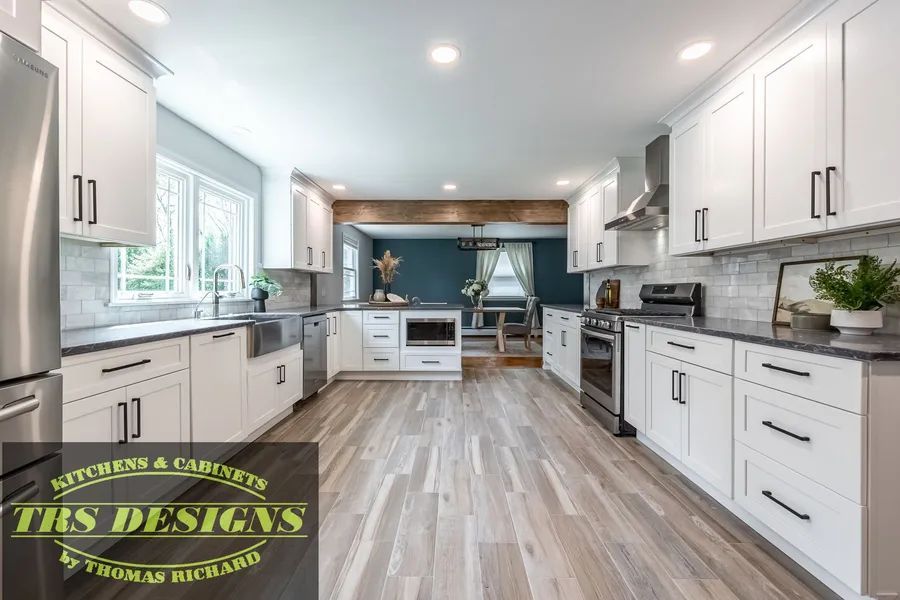 A kitchen with cabinets and steel appliances.