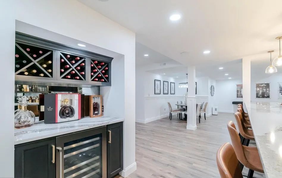 There is a wine cooler in the middle of the room.