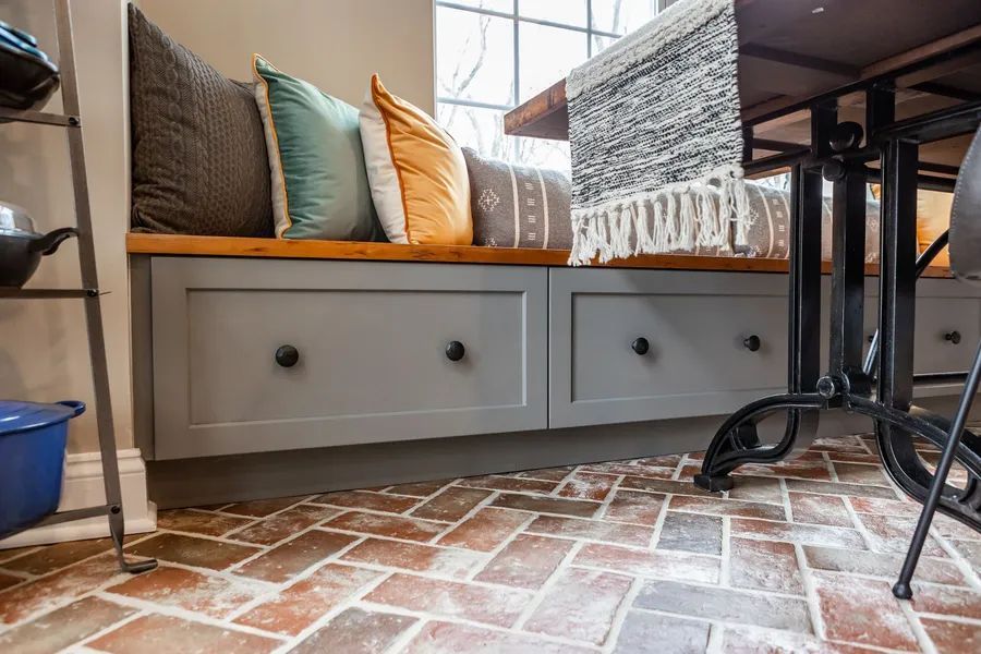 There is a bench with drawers underneath it in the kitchen.