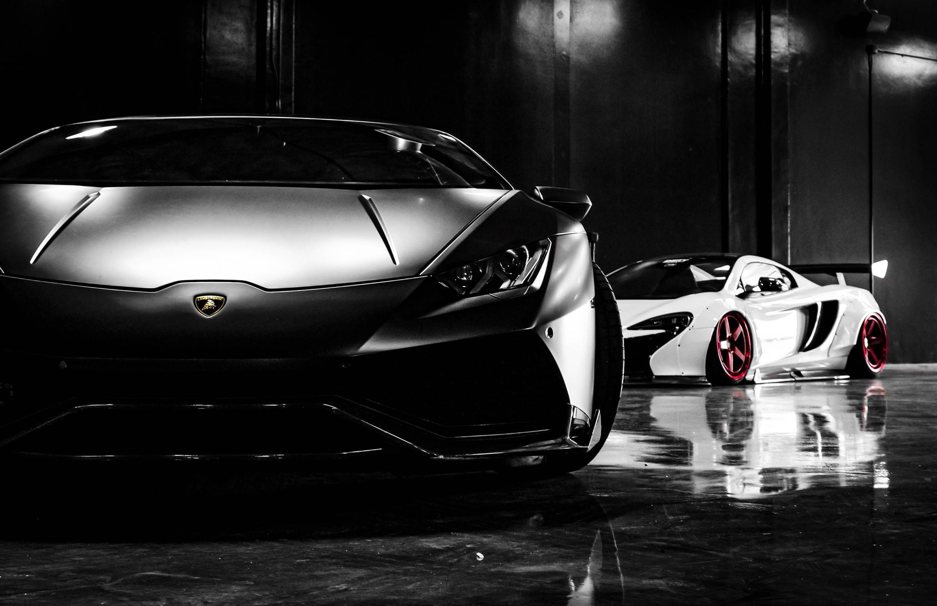 Black Lamborghini and white sports car in garage — First Class Decals and Details portfolio