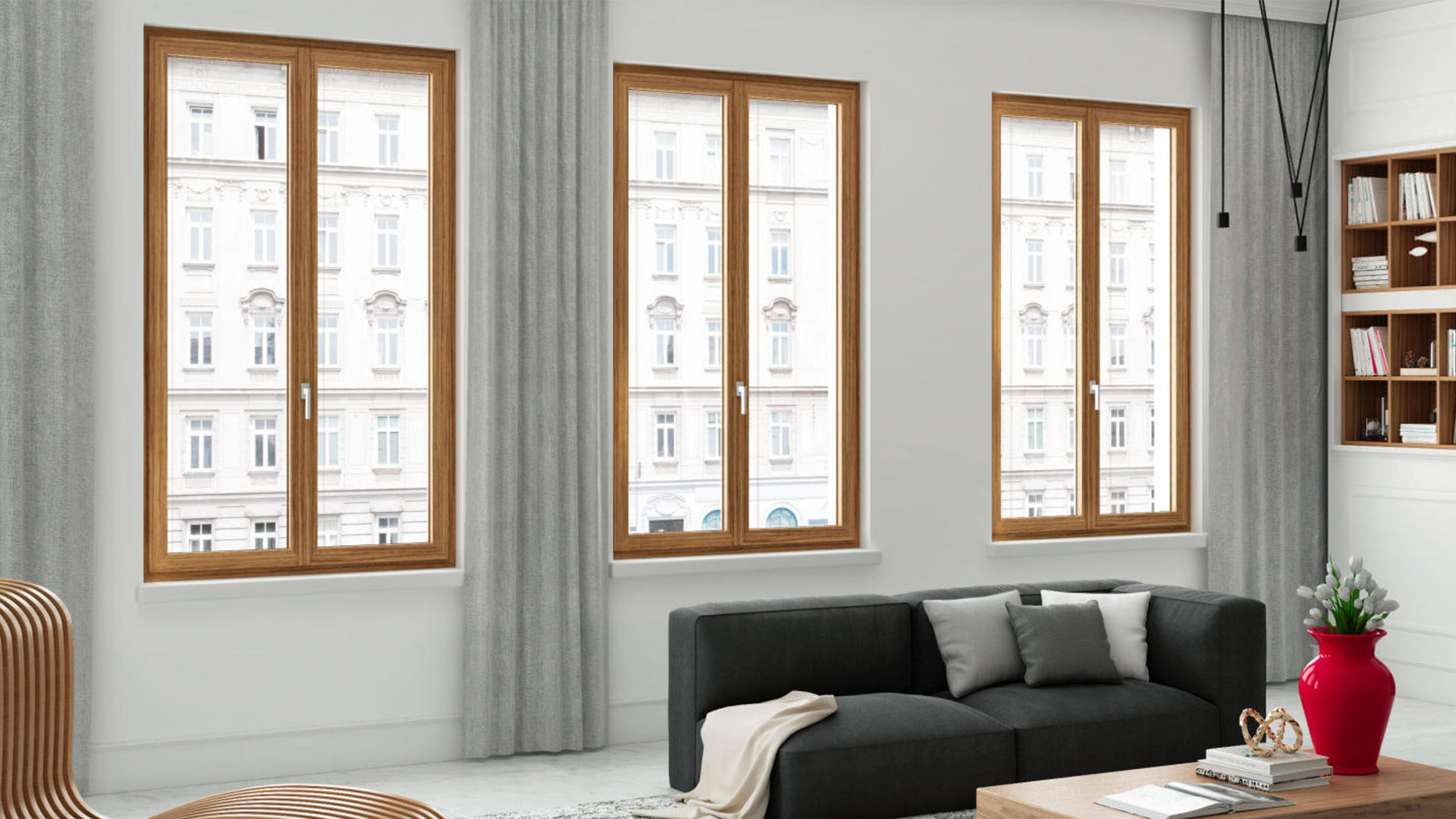 A living room with a couch , coffee table , and three windows.