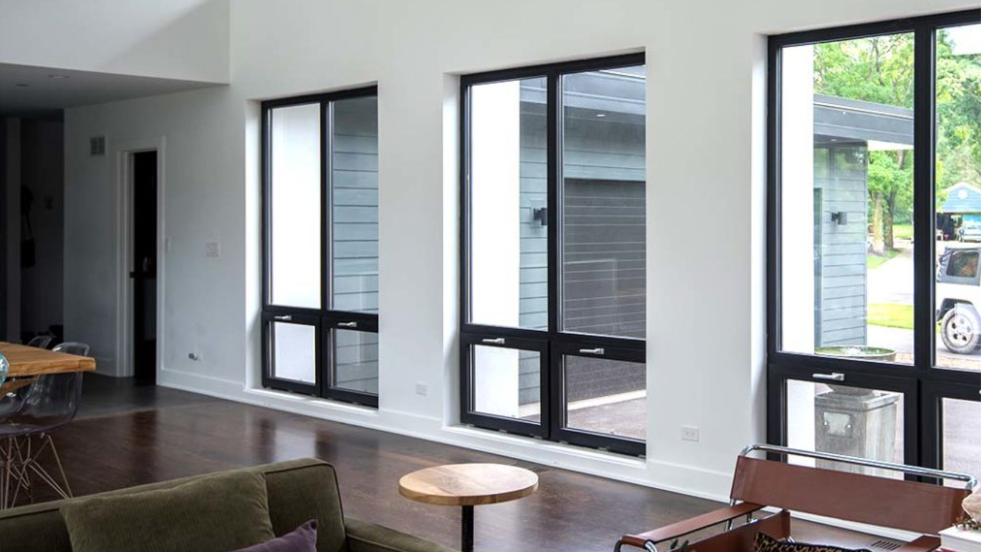 A living room with a lot of windows and a couch.