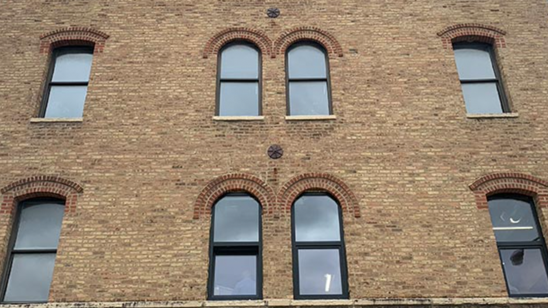 A brick building with a lot of windows on it
