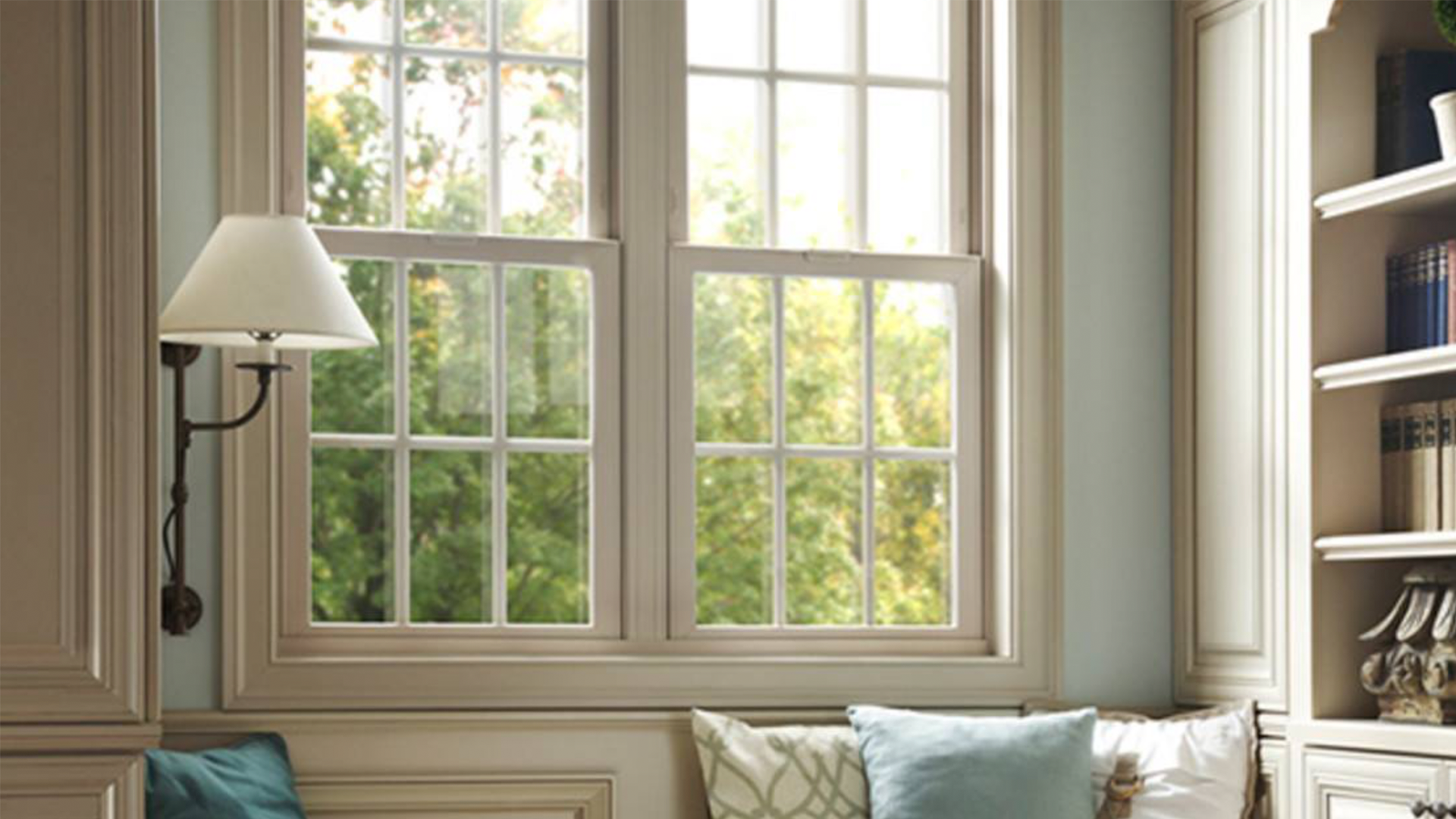 A living room with a window , a lamp , and a couch.