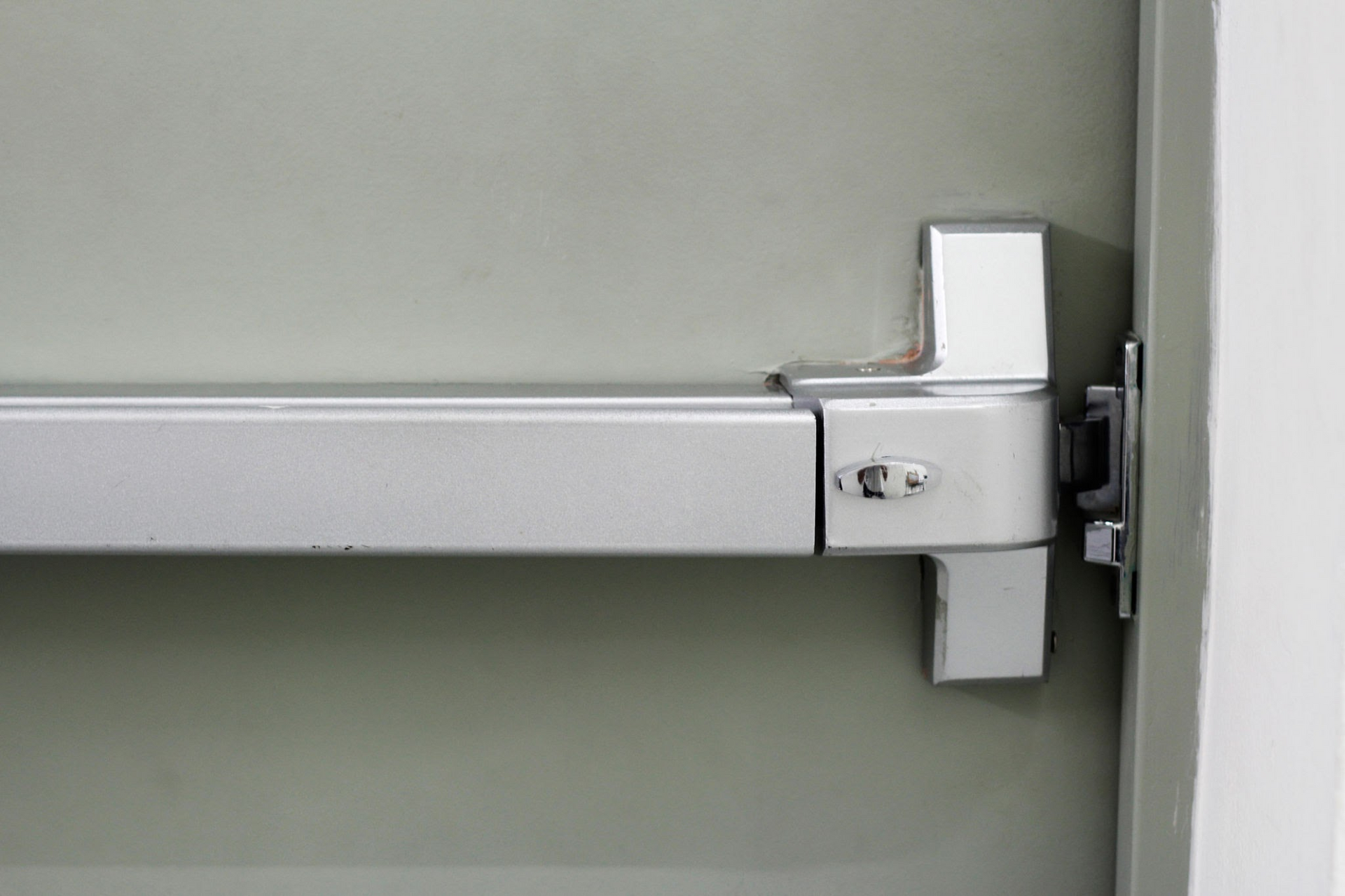 “Close-up of a commercial panic bar exit device installed on a secure emergency exit door.”