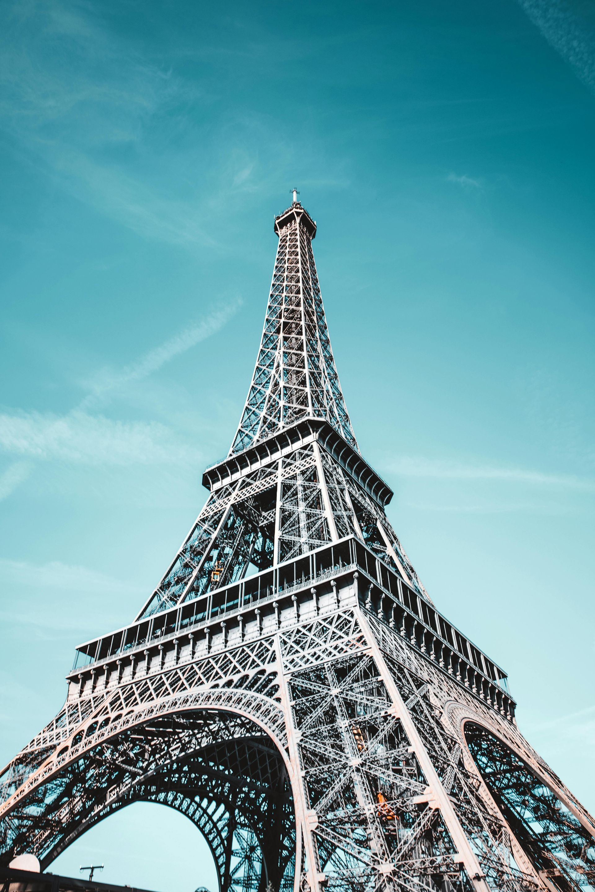 Eiffel Tower against a bright blue sky.